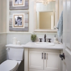 Tile wainscoting paired with wallpaper creates a visually appealing space.
